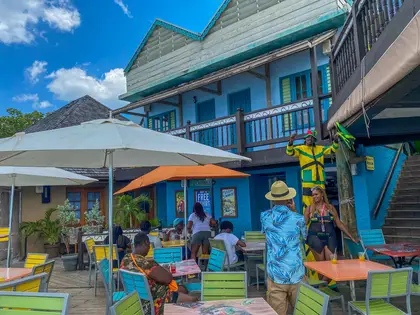 Visitors and vendors at a waterfront bar in Jamaica, where cash still dominates day-to-day trade