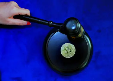 A gavel resting beside a Bitcoin token, representing the legal framework being written for digital assets in Jamaica